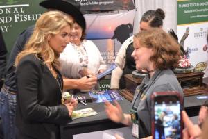 Role model for young shooters, Eva Shockey (L), talking with 4-H Teen Ambassador Logan Kimble-Lee (R) during the 2016 SHOT Show