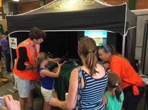 NYS4-HSS Instructor Denise Slocum (L), Yates County, with fairgoers at the Laser Shot Booth